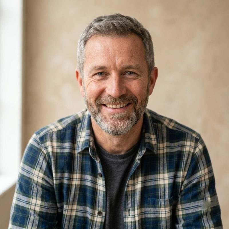 Smiling man in plaid shirt